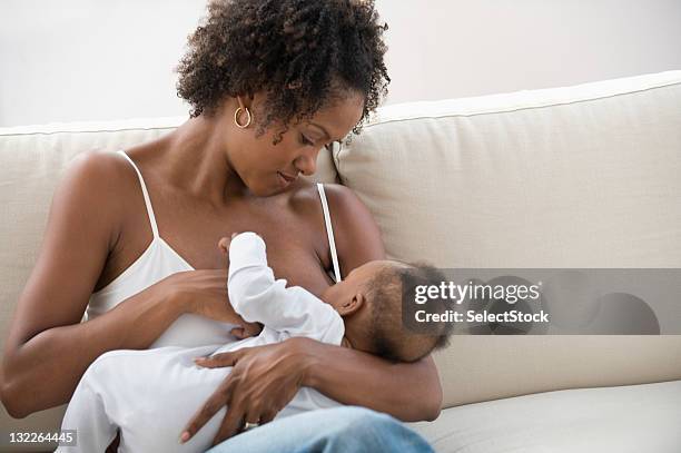 mother nursing son - black baby stock pictures, royalty-free photos & images