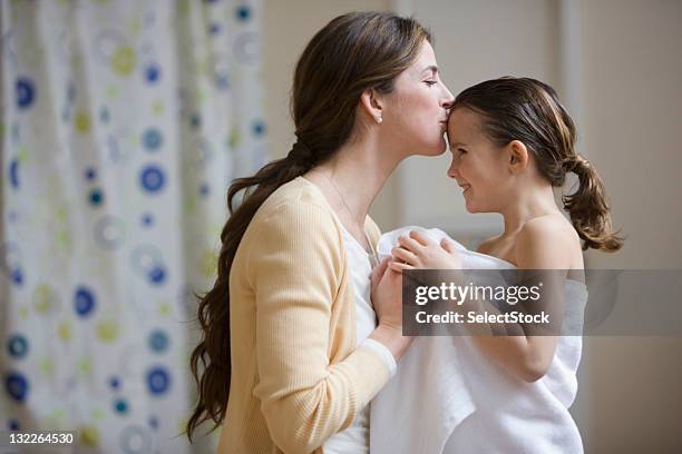 madre besando a la hija frente después de baño - mother daughter towel fotografías e imágenes de stock