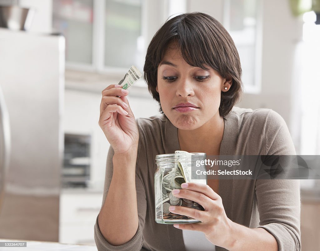 Woman with jar of cash