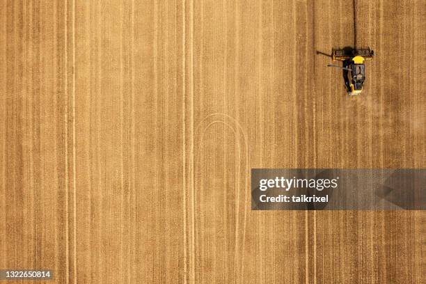 harvest of wheat from above - agricultural field aerial stock pictures, royalty-free photos & images