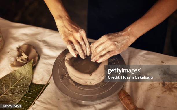 close-up view of female ceramic artist sculpting clay and making bowls. - molding a shape stock pictures, royalty-free photos & images