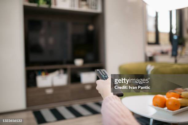 unrecognizable caucasian woman watching a tv at home - disconnect filme imagens e fotografias de stock