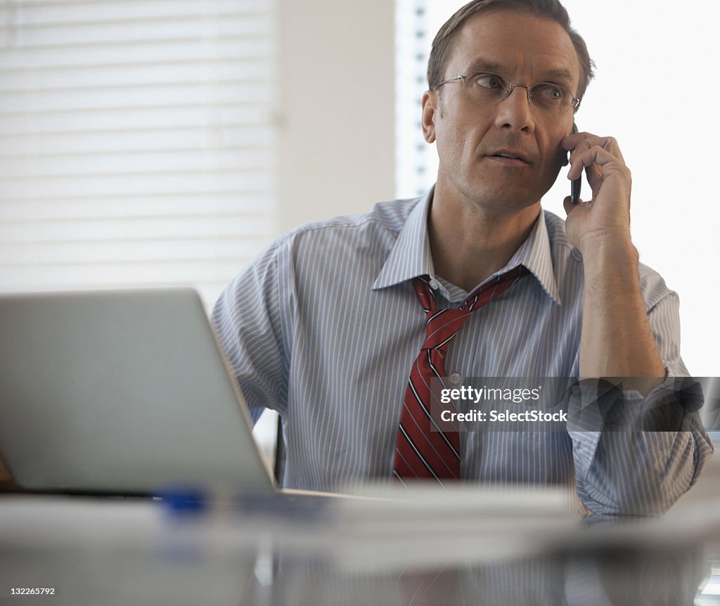 Businessman on mobile and laptop