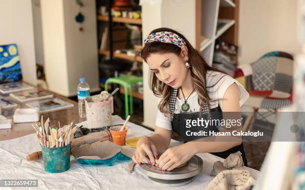 the ceramic artist is working on her new work created with clay and mud. - loam stock pictures, royalty-free photos & images