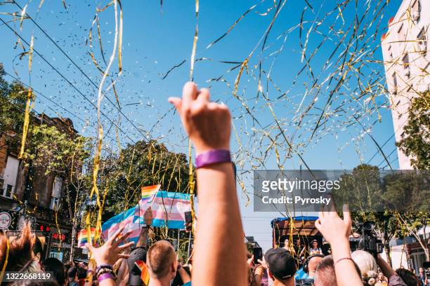lgbtqi pride march - rainbow confetti stock pictures, royalty-free photos & images