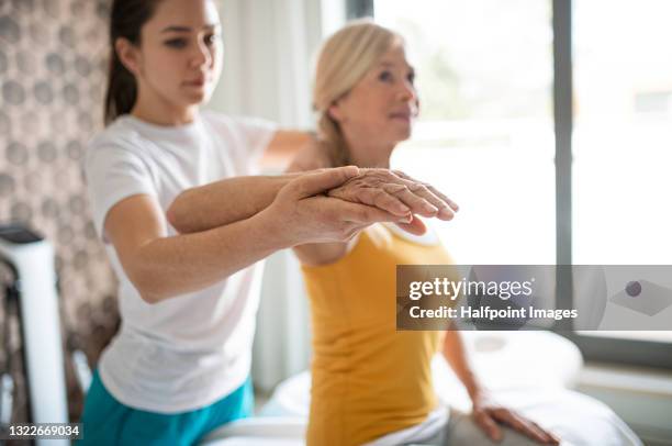 physiotherapist working with senior patient. - human joint stock pictures, royalty-free photos & images