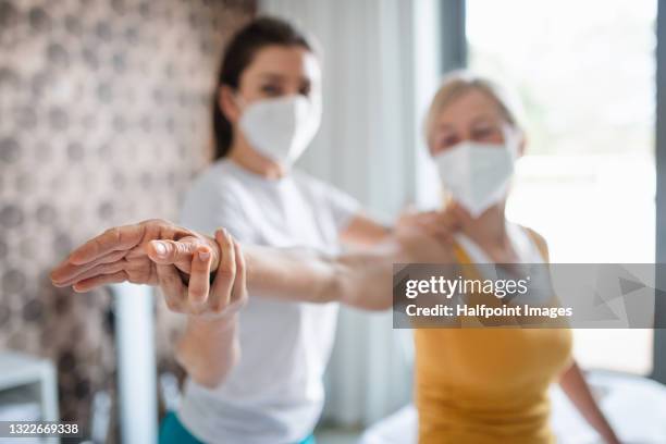 physiotherapist working with senior patient, coronavirus concept. - recovery fotografías e imágenes de stock