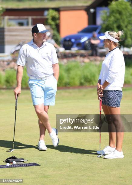 Jamie Donaldson of Wales chats with Amy Boulden of Wales on the putting green ahead of the Scandinavian Mixed Hosted by Henrik and Annika at Vallda...