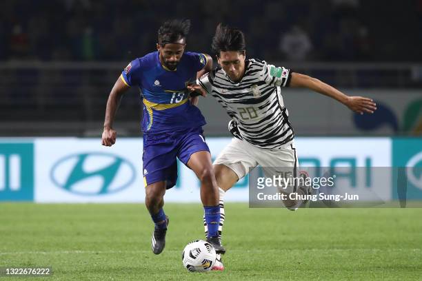 Ahmed Waseem of Sri Lanka competes for the ball with Won Du-Jae of South Korea during the FIFA World Cup Asian Qualifier 2nd round Group H match...