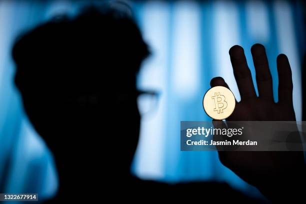 cryptocurrency bitcoin in hand - technology trade war stock pictures, royalty-free photos & images