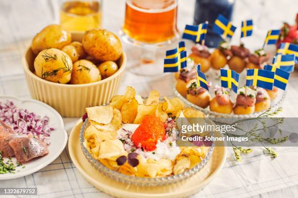 food for traditional midsummer feast - sweden flag stock-fotos und bilder