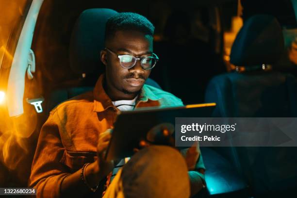 handsome young businessman using digital tablet in car - consumer journey stock pictures, royalty-free photos & images