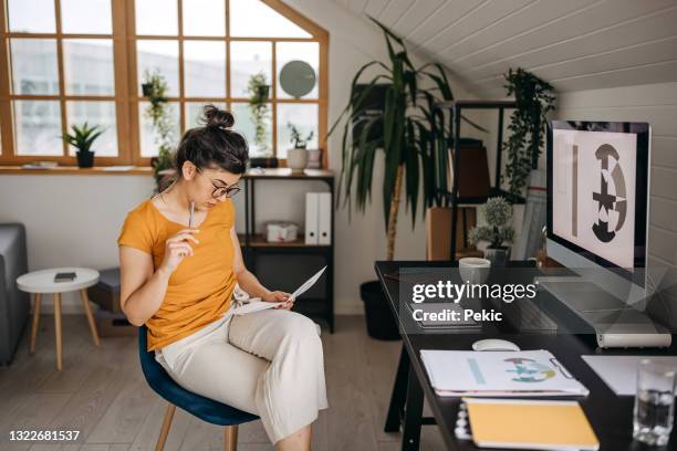 young female graphic designer working from new home office setup - editing room stock pictures, royalty-free photos & images