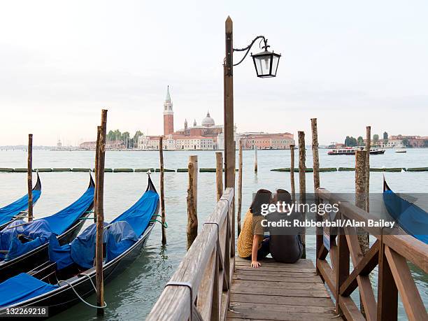 italy, venice, young couple embracing by canal - venice with couple stock pictures, royalty-free photos & images