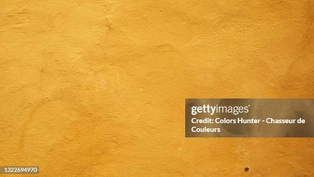 clean and textured yellow wall in paris - plaster stockfoto's en -beelden