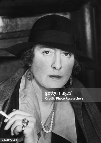 Portrait of British author and gardener Vita Sackville-West, Lady Nicolson , a cigarette in her hand, as she poses in her home at Sissinghurst...