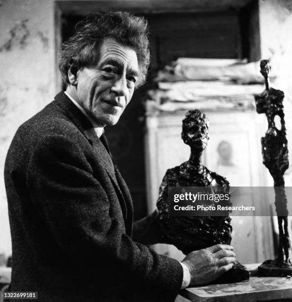 Portrait of Swiss artist Alberto Giacometti as he works on a sculpture in his studio, Paris, France, 1966.