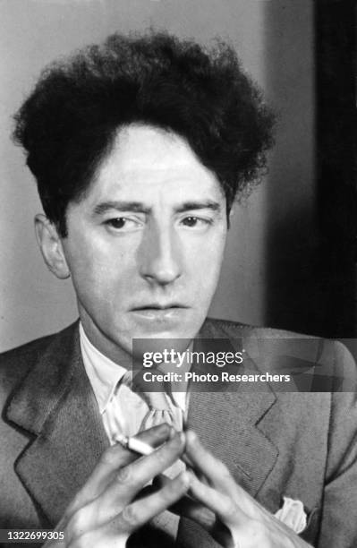 Portrait of French artist and writer Jean Cocteau , a cigarette in his hand, Paris, France, 1939.