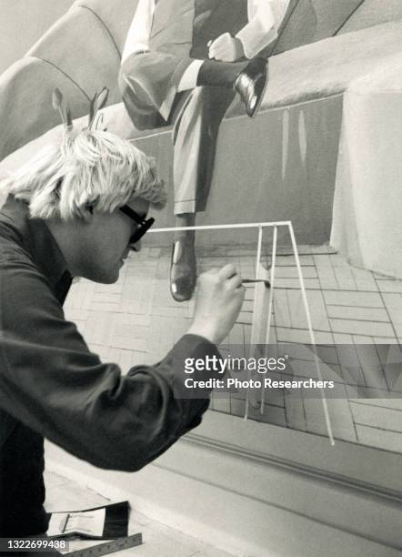 View of British Pop artist David Hockney as he paints in his Powis Terrace home studio, London, England, 1969. He is working, with acrylic paint, on...