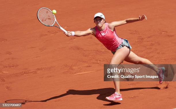 Iga Swiatek of Poland returns a ball in her Quarter Final match against Maria Sakkari of Greece during day eleven of the 2021 French Open at Roland...