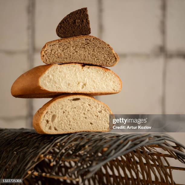 tower of different types of bread halves. white, dark, wheat and rye mixed bread. copy space at right side. soft focus - sliced white bread isolated stock pictures, royalty-free photos & images