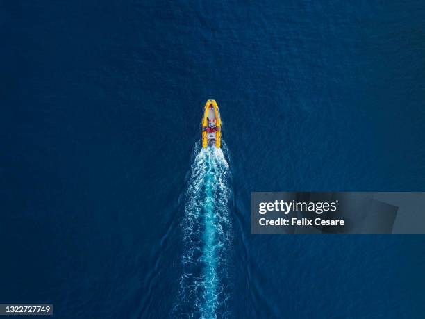 aerial view of a yellow rib inflatable boat. - beach rescue aerial stock-fotos und bilder