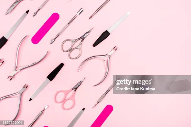 set of manicure tools on trendy pastel pink background. nail files, scissors, cuticle clippers. - nail file stock pictures, royalty-free photos & images