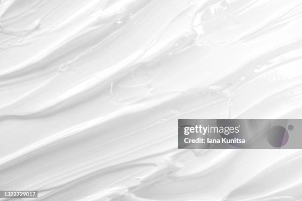 texture of white face cream is smeared. cosmetic products for makeup and skin care. - shaving cream stock pictures, royalty-free photos & images