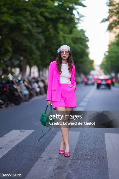 Ketevan Giorgadze @katie.one wears a white checkered and green scarf from Victoria Ragna, sunglasses, a white ribbed t-shirt, a pink fuchsia blazer...