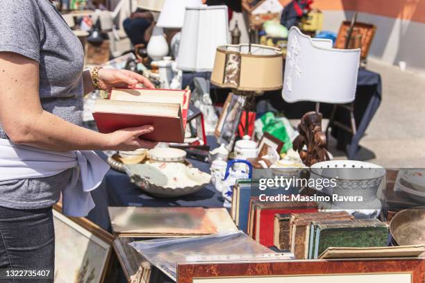 woman making purchases at the flea market - flea market stockfoto's en -beelden