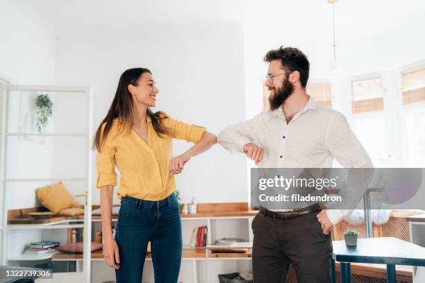 elbow bump - elbow greeting stock pictures, royalty-free photos & images