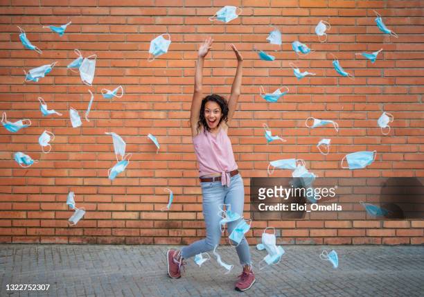 the end of quarantine throwing masks celebrating victory over coronavirus pandemic - the end stock pictures, royalty-free photos & images