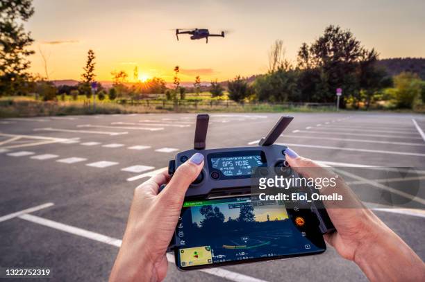 dji mavic pro 2 drone and remote controller pov - command and control imagens e fotografias de stock