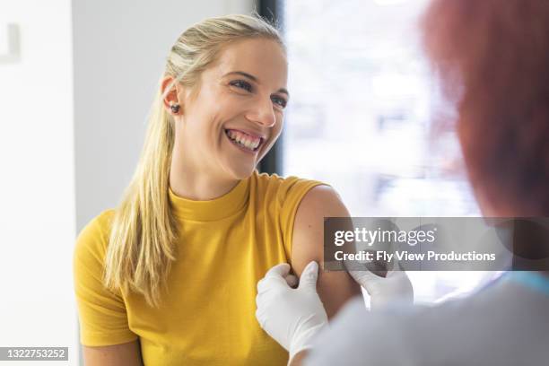 a happy patient that just received the vaccine - flu epidemic stock pictures, royalty-free photos & images