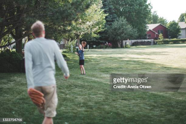 man and boy playing catch - playing catch stock pictures, royalty-free photos & images