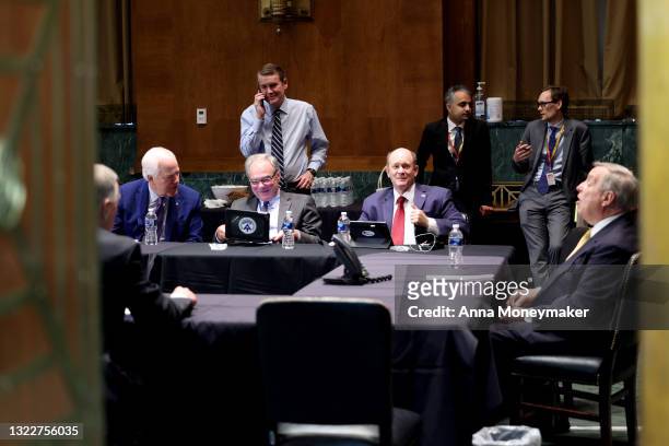 Sen. John Cornyn , Sen. Tim Kaine , Sen. Michael Bennet Sen. Chris Coons and Sen. Richard Durbin sit at a table before the start of a closed door...