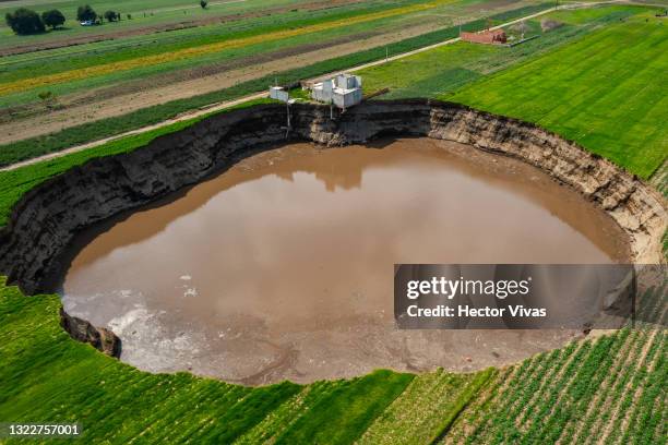 Aerial view of a giant sinkhole on June 09, 2021 in Santa María Zacatepec, Mexico. The giant sinkhole is located 20 kilometers northwest from the...