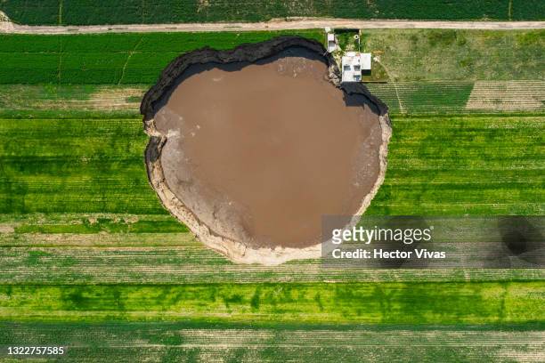 Aerial view of a giant sinkhole on June 09, 2021 in Santa María Zacatepec, Mexico. The giant sinkhole is located 20 kilometers northwest from the...