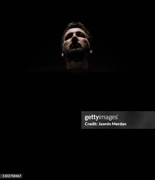 adult man in dark - clair obscur stockfoto's en -beelden