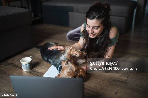 young woman taking a break from studies - dog pad stock pictures, royalty-free photos & images