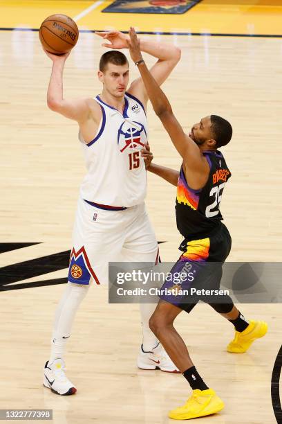 Nikola Jokic of the Denver Nuggets looks to pass around Mikal Bridges of the Phoenix Suns during the first half in Game Two of the Western Conference...