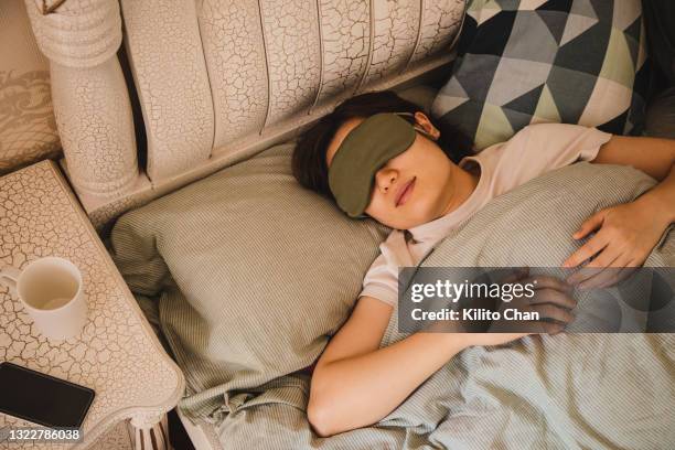 asian woman sleeping on bed in the morning - sleeping and bed bildbanksfoton och bilder