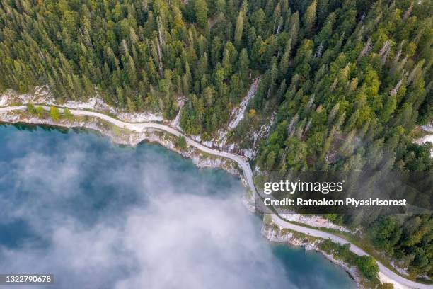 aerial drone sunrise fog and mist scene landscape of mountain and lake at gosausee lake, gosauseen are three lakes in the south-western, alpine part of upper austria - bergsee stock-fotos und bilder