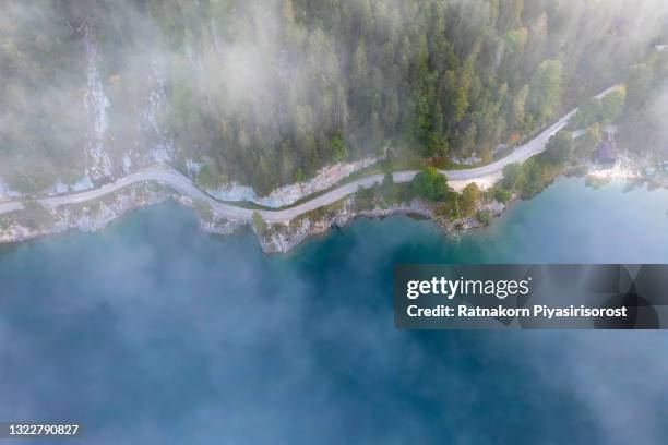 aerial drone sunrise fog and mist scene landscape of mountain and lake at gosausee lake, gosauseen are three lakes in the south-western, alpine part of upper austria - bergsee stock-fotos und bilder