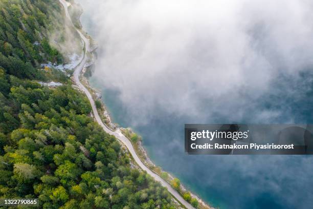 aerial drone sunrise fog and mist scene landscape of mountain and lake at gosausee lake, gosauseen are three lakes in the south-western, alpine part of upper austria - bergsee stock-fotos und bilder