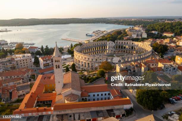 aerial view of sunset scene of pula city and the pula arena is a roman amphitheater located in pula, croatia - pula croatia stock pictures, royalty-free photos & images