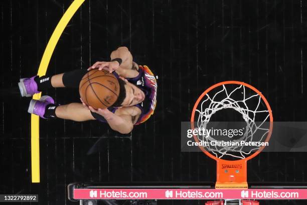 Devin Booker of the Phoenix Suns slam dunks the ball against the Denver Nuggets during the first half in Game Two of the Western Conference...