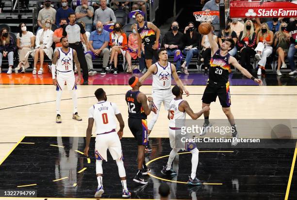 Dario Saric of the Phoenix Suns slam dunks the ball over Will Barton of the Denver Nuggets during the first half in Game Two of the Western...