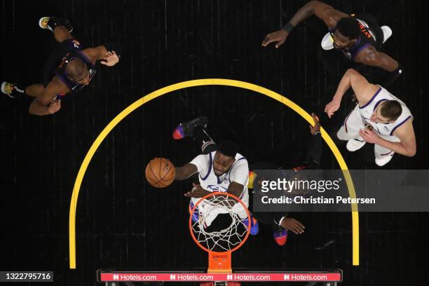 JaMychal Green of the Denver Nuggets lays up a shot past Jae Crowder of the Phoenix Suns during the second half in Game Two of the Western Conference...