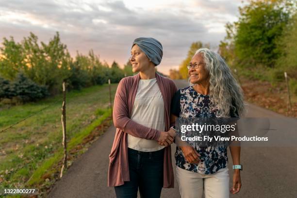 woman with cancer feeling positive about the future - eurasian female stock pictures, royalty-free photos & images
